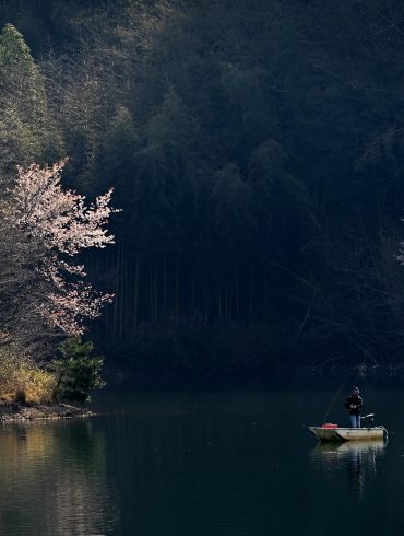 a person in a boat on a lake